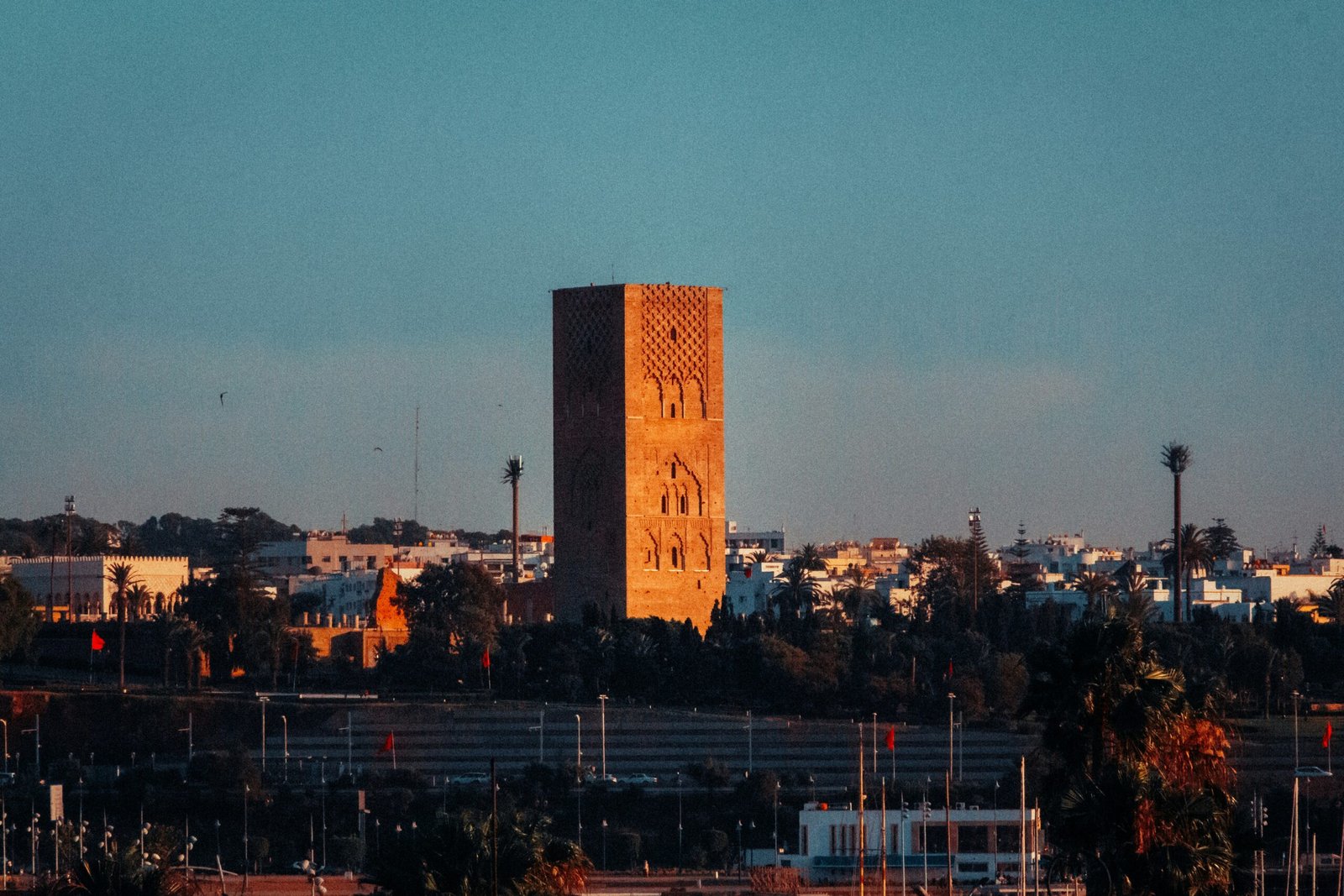 A stunning panoramic view of the rectangular Hassan Mosque minaret in Rabat Morocco travel. This iconic landmark showcases the beauty of historical architecture, making it a unique destination for heritage enthusiasts.